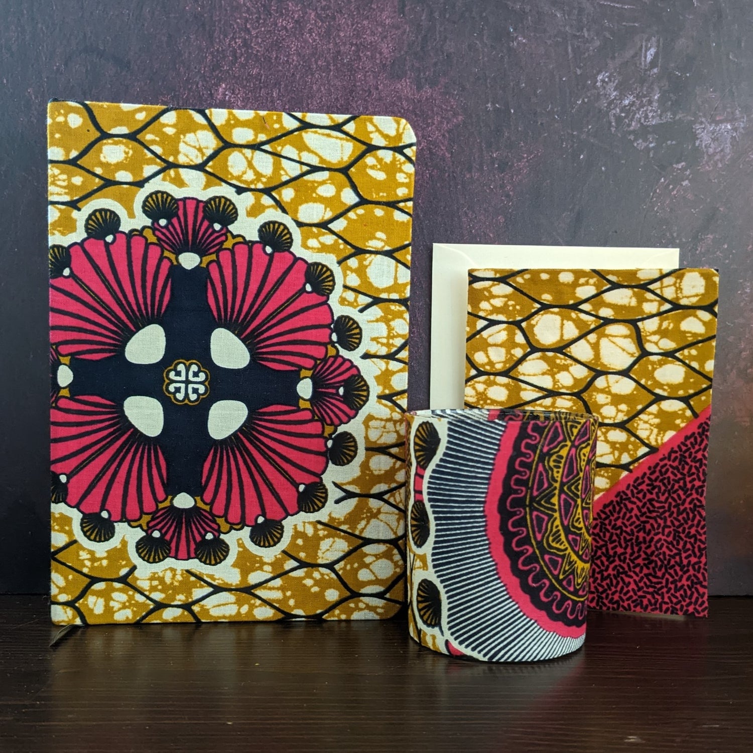 Image shows an African wax print gift set. It includes an A5 journal candle holder &  card with an envelope.
