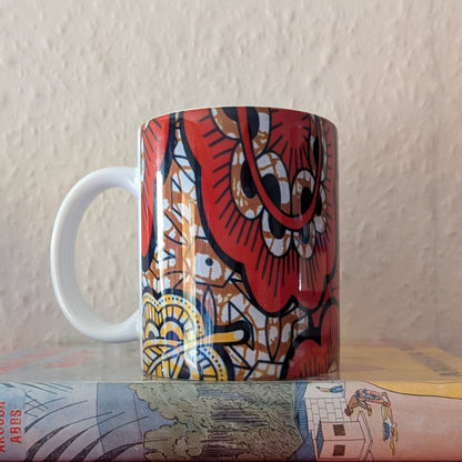 Copper yellow coloured mug with a paisley leaf design on a white background