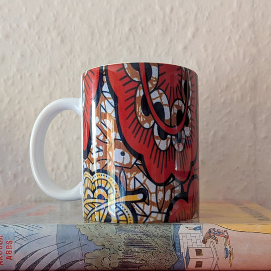 Copper yellow coloured mug with a paisley leaf design on a white background