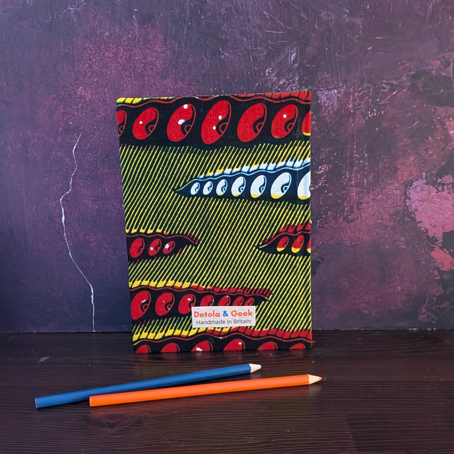 African Patterned A5 Lined Notebook FIOFIO: Mustard with blue red white pigeon pea pods