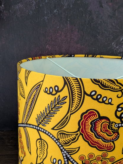 Yellow patterned lampshade on a dark background