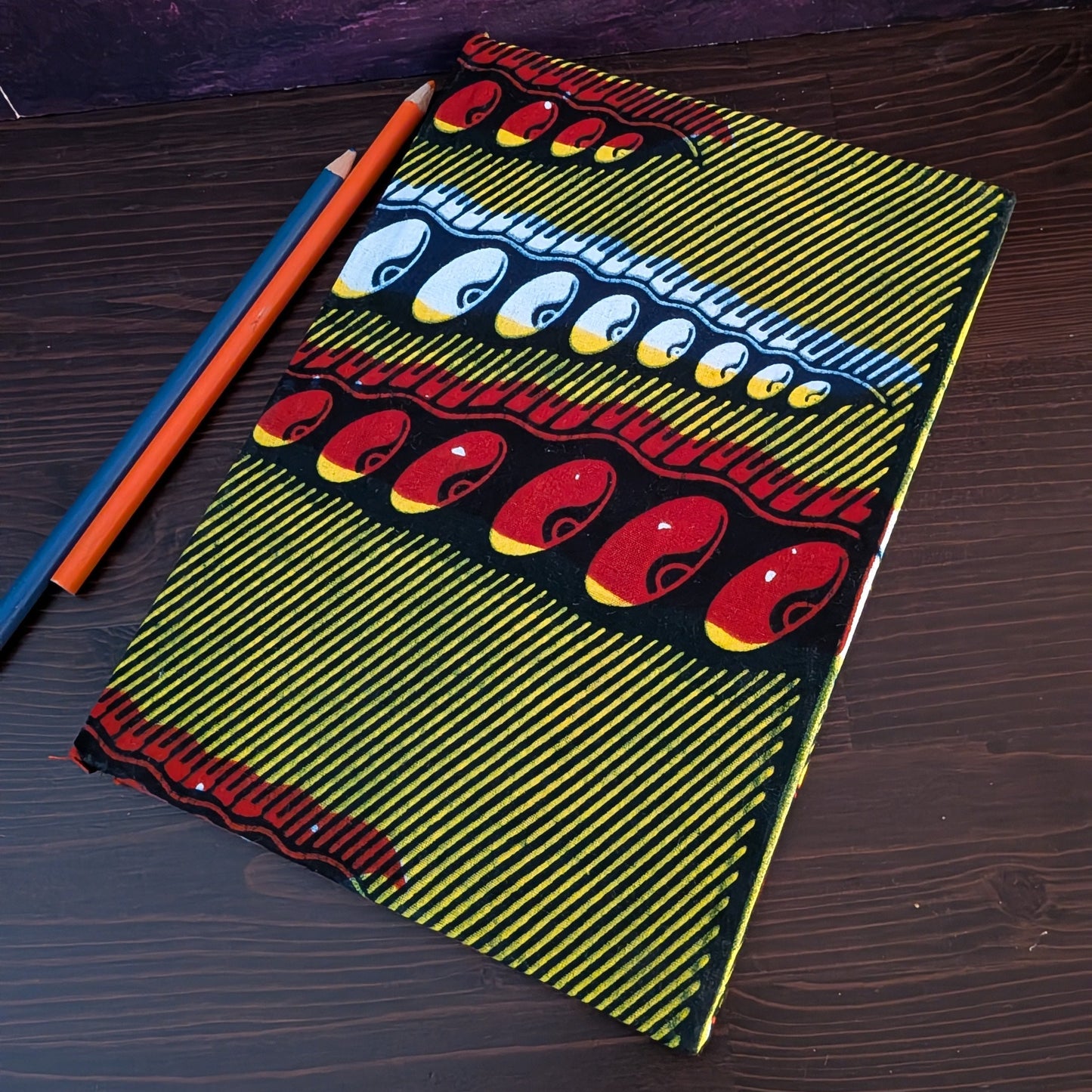 African Patterned A5 Lined Notebook FIOFIO: Mustard with blue red white pigeon pea pods