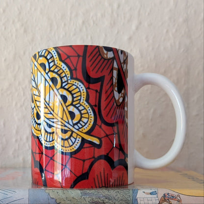 Copper yellow coloured mug with a paisley leaf design on a plain background